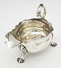 An Antique Georgian Sterling Silver Sauce Boat. C scroll handle and standing on three webbed Image - 2