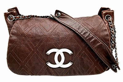A Chanel Brown Diamond Stitch Flap Bag. Leather exterior with silver-toned hardware, chain and