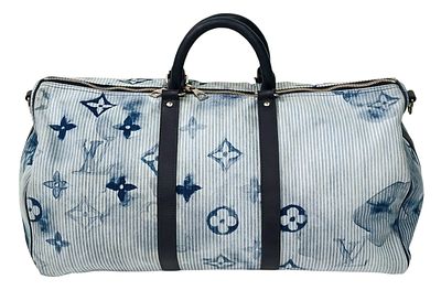 A Louis Vuitton Keepall Bandoulier 50 Bag. Denim and leather exterior with silver-toned