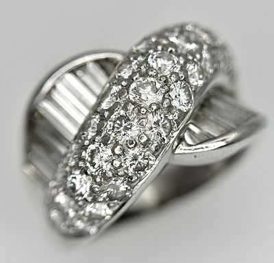 A Head-Turning 18K White Gold Diamond Crossover Ring. 3.87ctw brilliant round cut and baguette