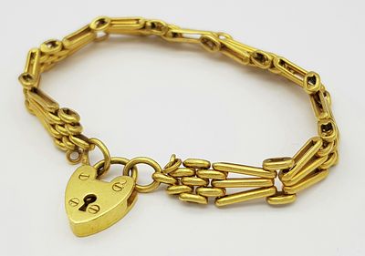 A Vintage, Possibly Antique 15K Yellow Gold (tests as) Gate Bracelet with Heart Clasp. 17cm. 14.75g.