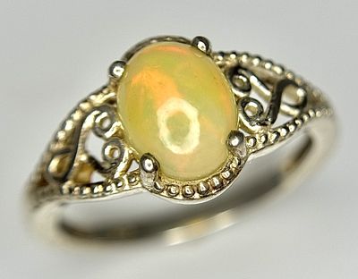 A Vintage Sterling Silver Opal Set Ring Size P. The Ring is set with a 9mm Oval Cut Opal