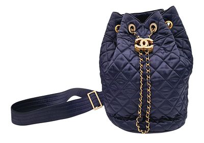 A Chanel Coco Navy Blue Bucket Bag. Quilted textile exterior with gold-toned hardware
