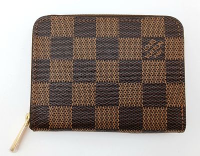 A Louis Vuitton Damier Ebene Zipper Coin Purse. Brown Damier Ebene coated canvas exterior with