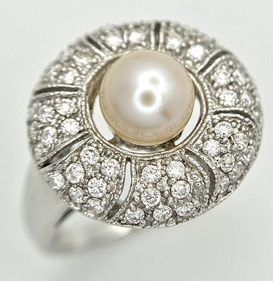 A Vintage 18K White Gold Diamond and Pearl Ring. 0.28ctw diamonds, 6.2g total weight, ring size