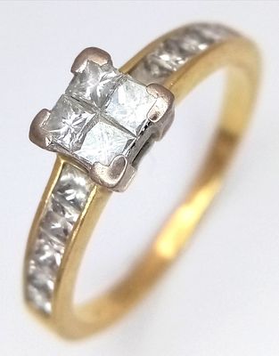 AN 18K GOLD DIAMOND SET RING WITH DIAMOND SHOULDERS. 3.8gms size V