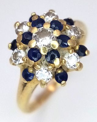 An 18K Yellow Gold Sapphire and Diamond Cluster Ring in Floral Form. Size J. 3.43g.