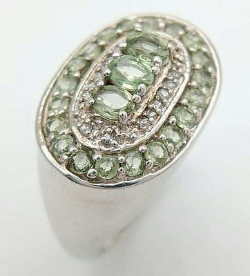 A Pretty Sterling Silver Peridot and White Sapphire Set Ring Size S. The Ring measures 2cm Long 