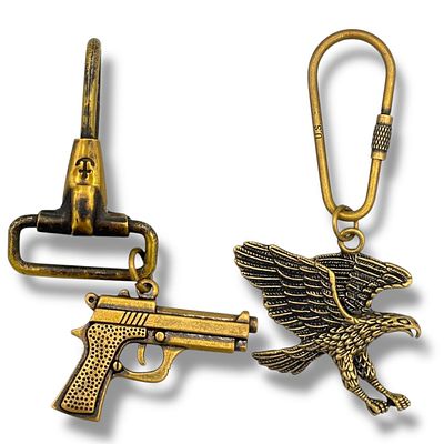 Two Vietnam war era U.S. army Brass Keychains with Pistol and Eagle Charms. Approximately 9cm 