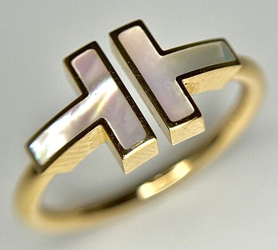 A Tiffany and Co. 18K Yellow Gold and Mother of Pearl Ring. Size N 1/2. 3.96g. Comes with 
