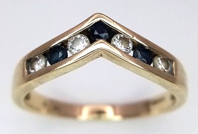 A 9K Yellow Gold Blue and White Zircon Channel Set Ring. Size M. 1.9g.