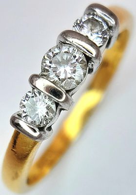 An 18K Yellow Gold Three Stone Diamond Ring. c. 0.30ctw. Size L 1/2. 2.85g.
