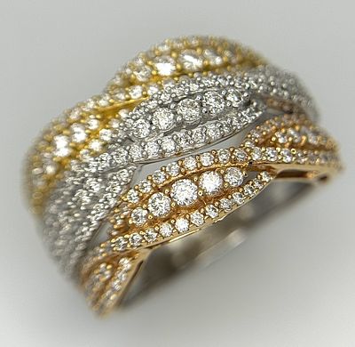 An 18K White and Yellow Gold Diamond Crossover Ring. c. 3ctw of small round brilliant cut 