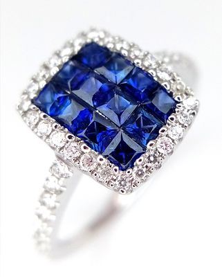 An 18K White Gold, Sapphire and Diamond Ring. Checkerboard sapphires - 0.70ctw with a diamond 