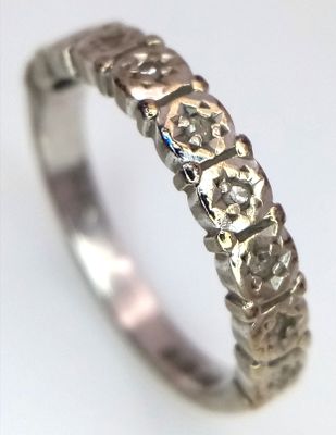 A 9K GOLD DIAMOND SET HALF ETERNITY RING . 2.4gms size L