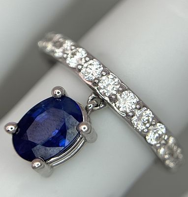 A 14k White Gold Sapphire and Diamond Ring. A Beautiful hanging oval cut blue sapphire with a 