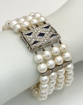 A FOUR ROW AKOYA PEARL BRACELET WITH A 14K WHITE GOLD DIAMOND AND SAPPHIRE SET CLASP. A 