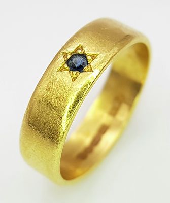 A 22K Yellow Gold Band Ring with Sapphire Star Set Gemstone. 6mm width. Size J. 4.3g.