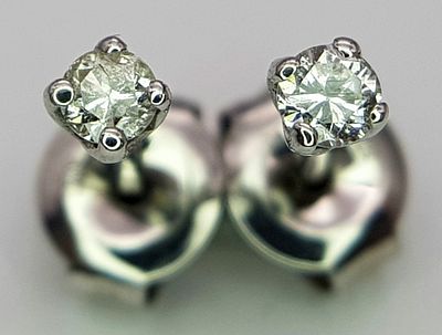 A PAIR OF 9K WHITE GOLD DIAMOND SET STUD EARRINGS. 0.15CT 0.7G . Ref: MB 7001