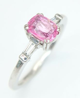 A 950 Platinum, Pink Sapphire and Diamond Ring. 0.6ct oval cut sapphire with tapered baguette 