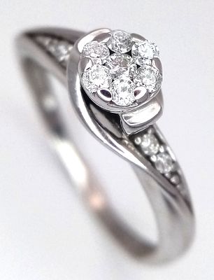 A 9K WHITE GOLD DIAMOND SET TWIST RING 0.15CT 2G SIZE M. Ref: SC 7033
