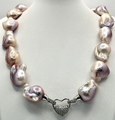 A stunning cultured baroque pearl necklace completed with a decorative silver stone set heart 