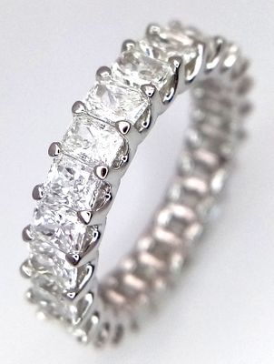 An 18K White Gold Diamond Full Eternity Ring. C. 4.5ctw of radiant cut high grade diamonds. 
