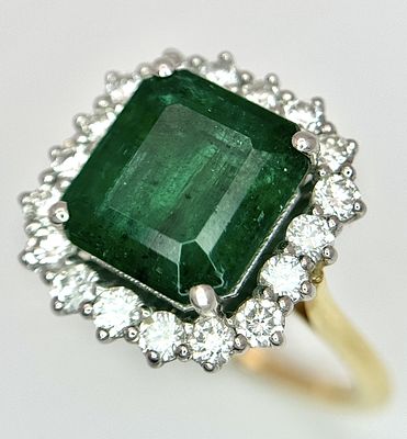 A W.G.I Certified 18K Yellow Gold, 950 Platinum, Emerald and Diamond Ring. An octagonal cut 