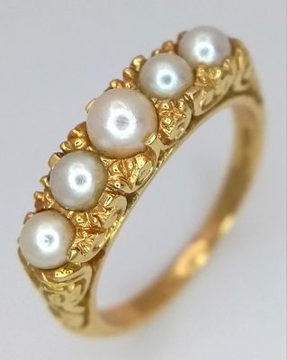 AN 18K GOLD RING IN CLASSIC STYLE WITH 5 PEARLS SET TO TOP . 5.4gms size O