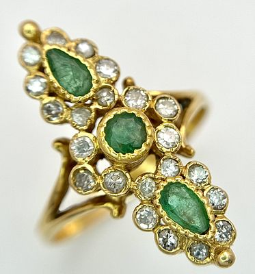 AN 18K YELLOW GOLD, DIAMOND AND EMERALD SET, MARQUISE SHAPED, COCKTAIL RING. 4.7G, SIZE Q. TAN 2002