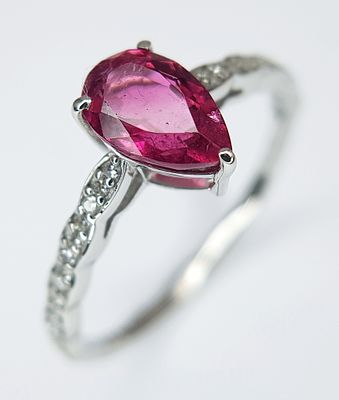 A 950 PLATINUM, 1.12ctw Brazilian Pink Tourmaline Ring with Diamond Accents. A 1.03ct pear 