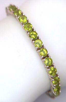 A Sterling Silver Peridot Set Tennis Bracelet-19.5cm Length. Set with Forty-Two 3.5mm Round Cut 