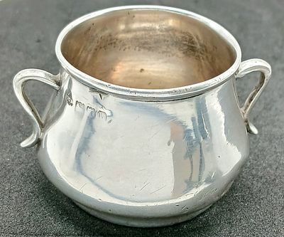 An Antique Sterling Silver Twin-Handled Cup. London hallmarks, 1903. Approx 5.5cm x 4cm. Total 