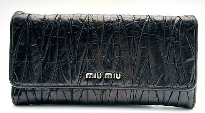 A Miu Miu Nappa Matelass&eacute; Flap Wallet. Black matelass&eacute; pleated leather exterior with 