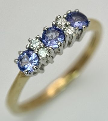 A Beautiful 9k Yellow Gold Tanzanite and Diamond Set Ring Size N. The Ring is set with three 