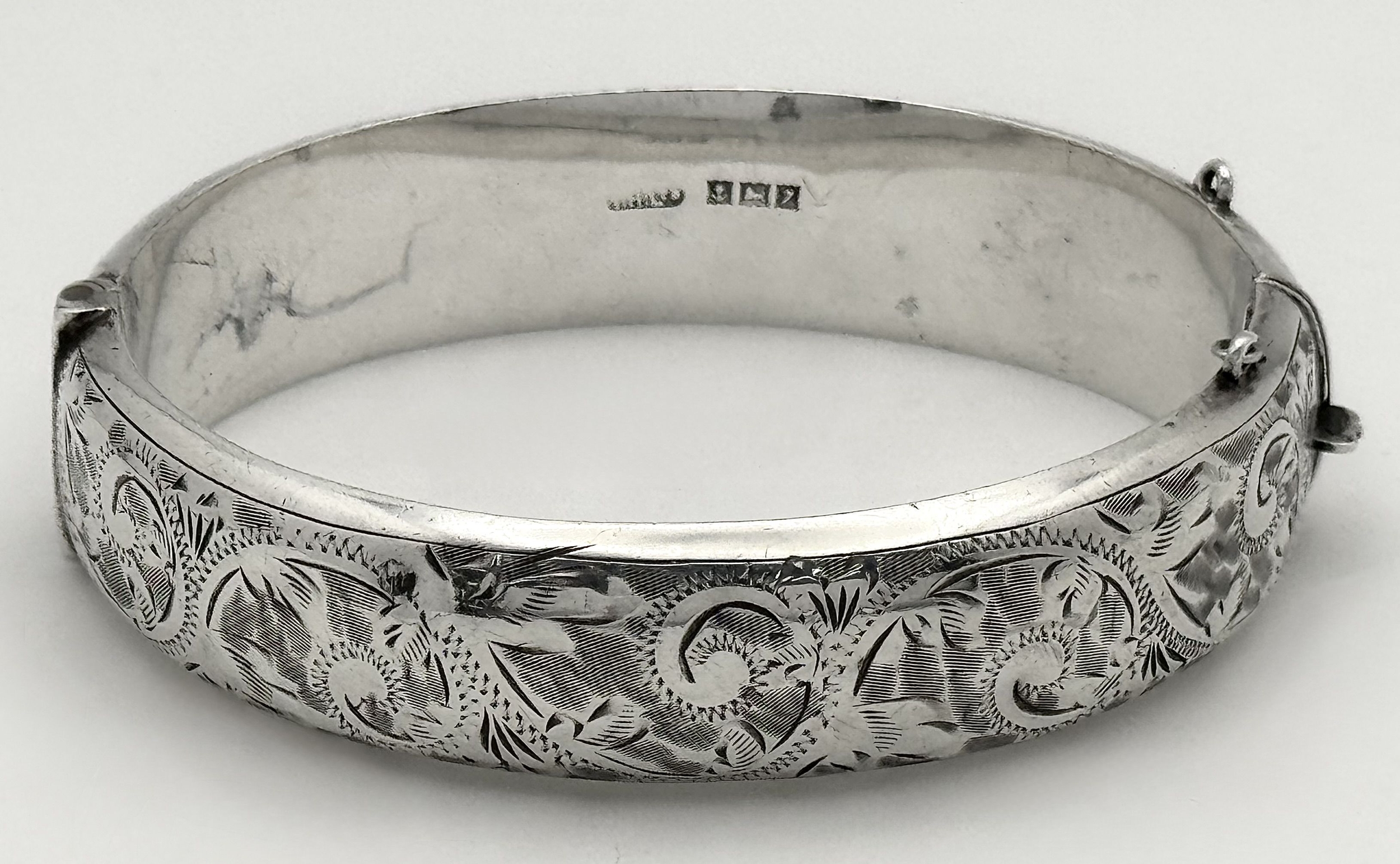 A vintage sterling silver click-on bangle