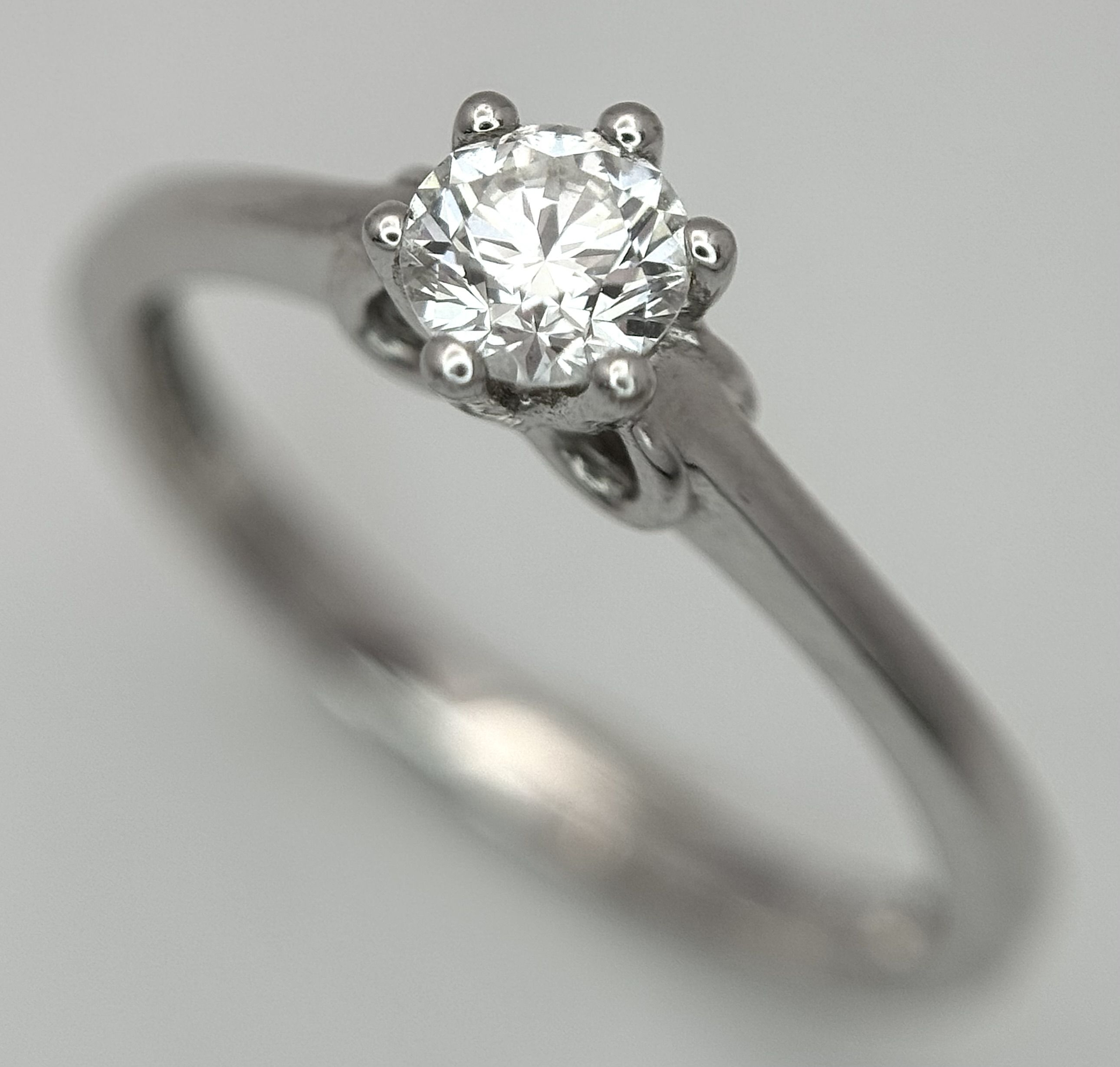 An 18K White Gold and Diamond Solitaire Ring