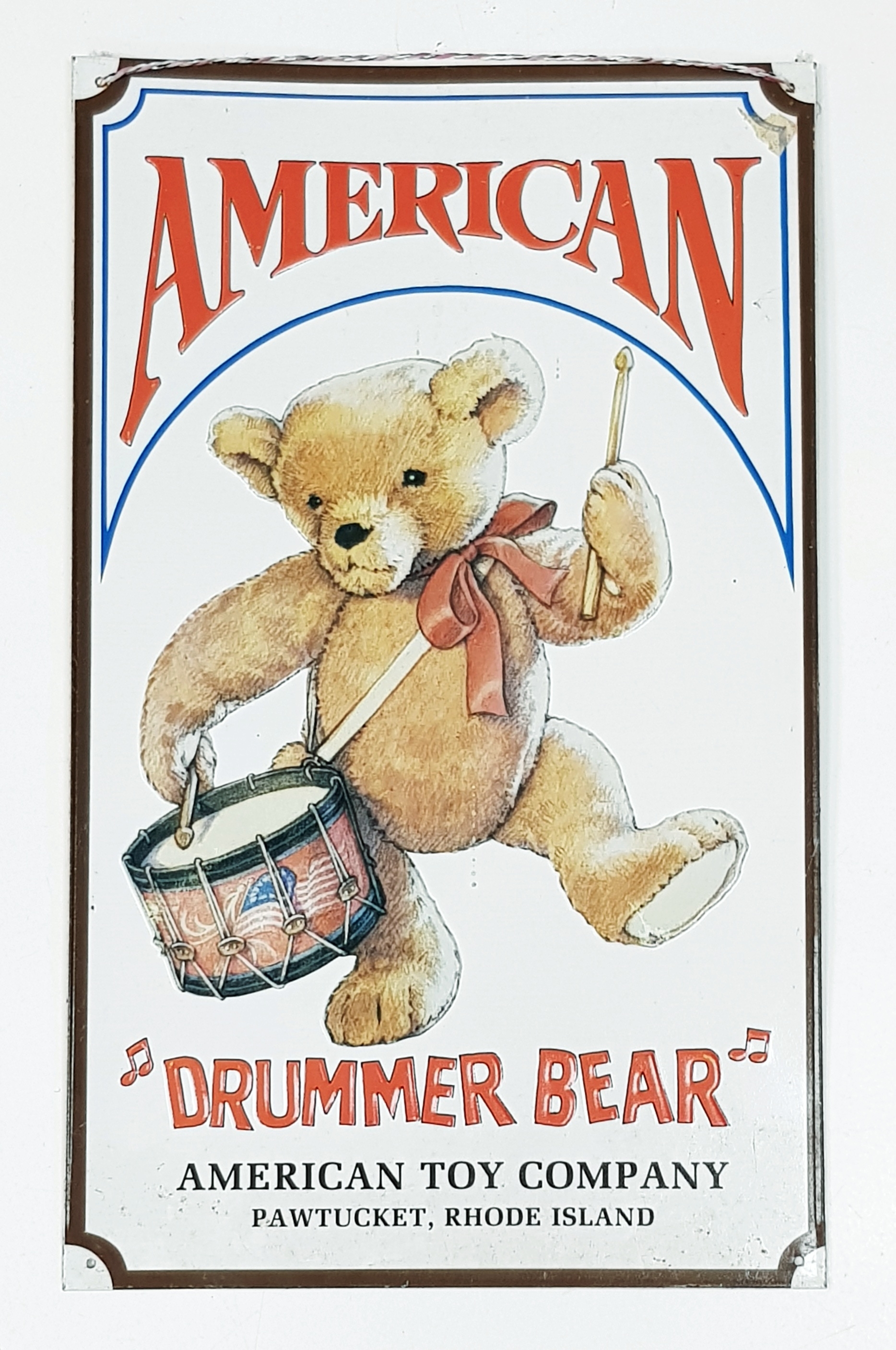 A Vintage American Drummer Bear, American Toy Company Metal Sign