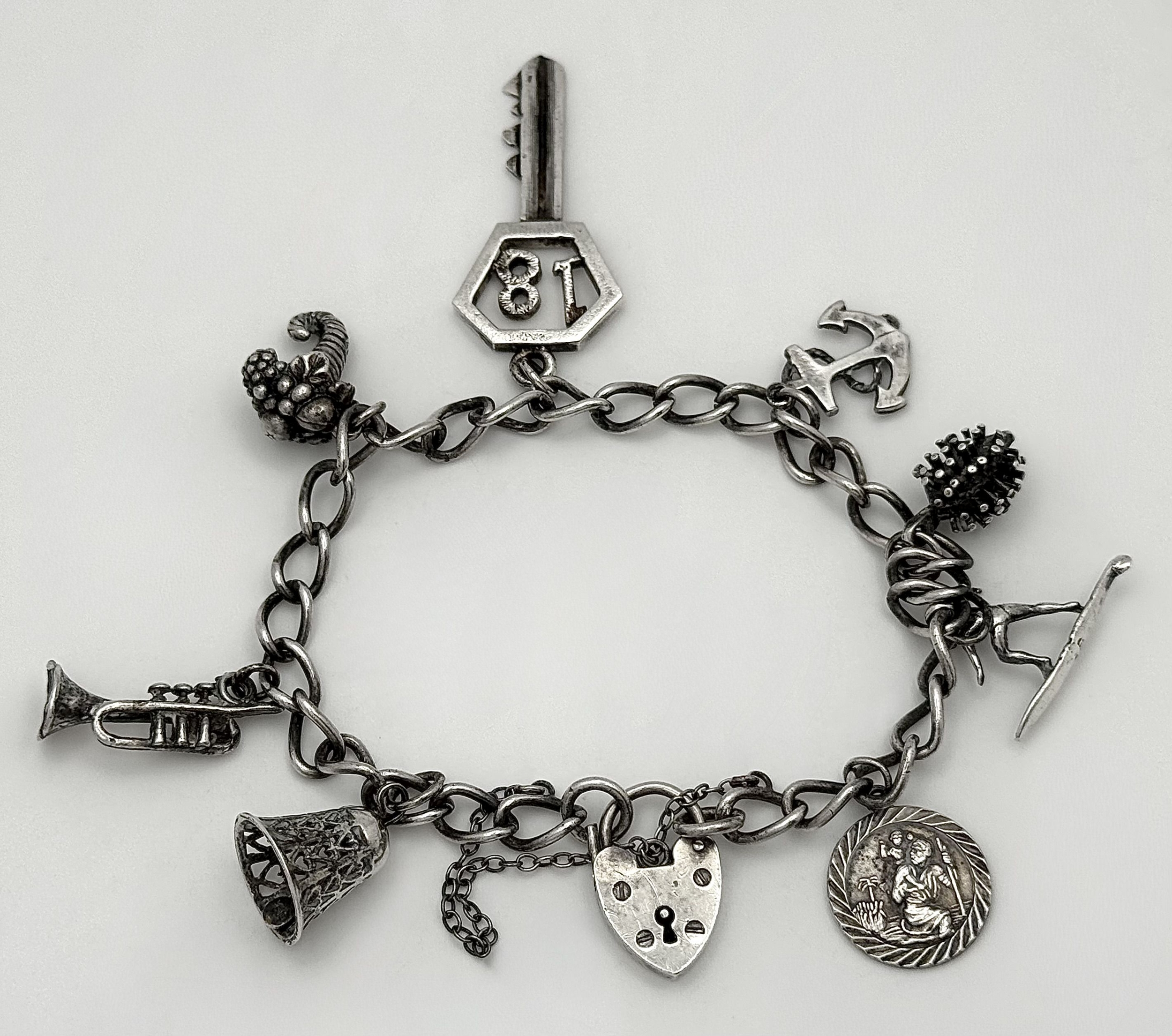 A vintage sterling silver multi-charm bracelet