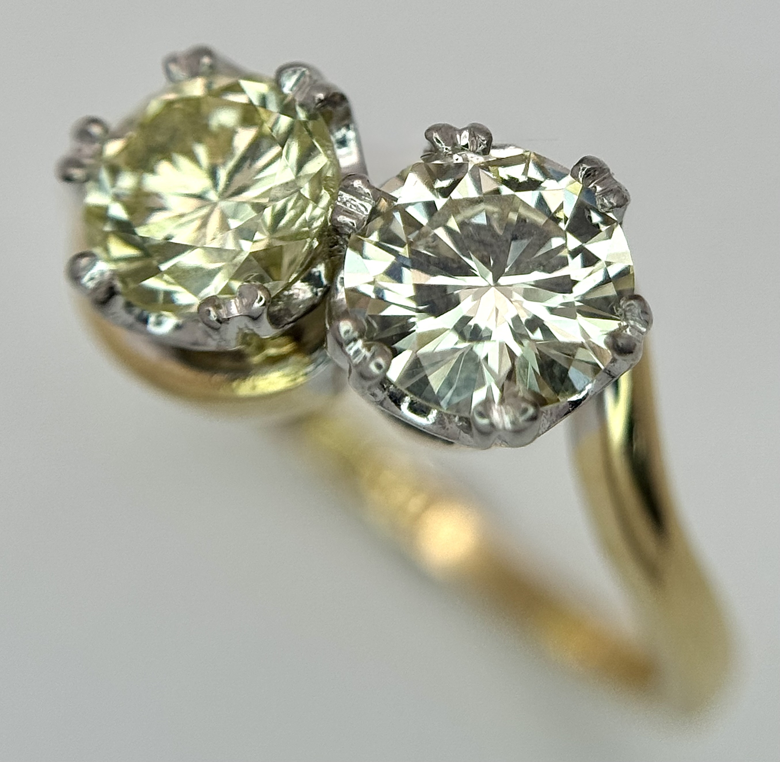 An 18K Yellow Gold and Diamond Crossover Ring. c.1.5ctw of Yellow tinted round