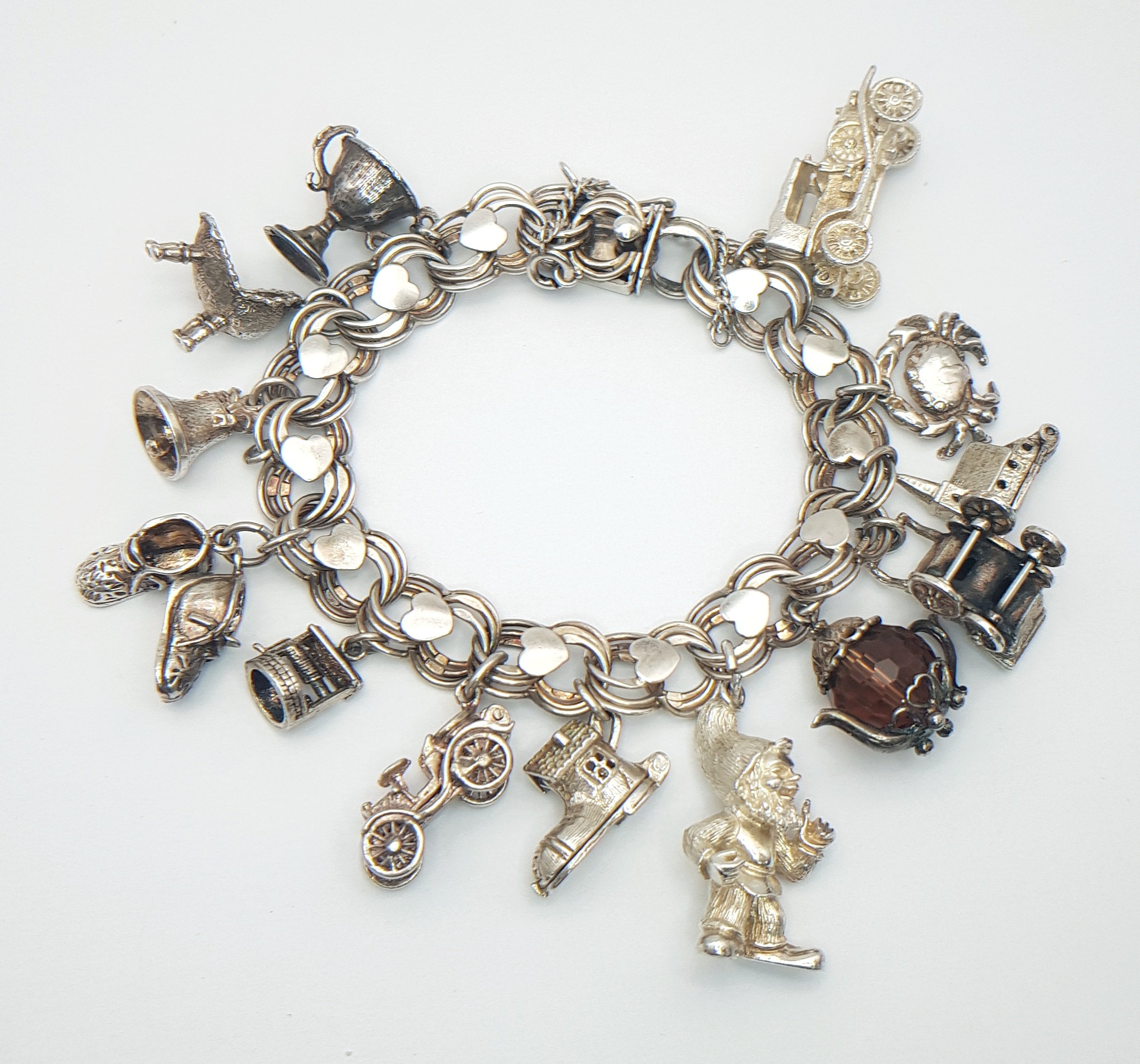 A Sterling Silver Heart Double Link Charm Bracelet with Mixed Novelty Charms