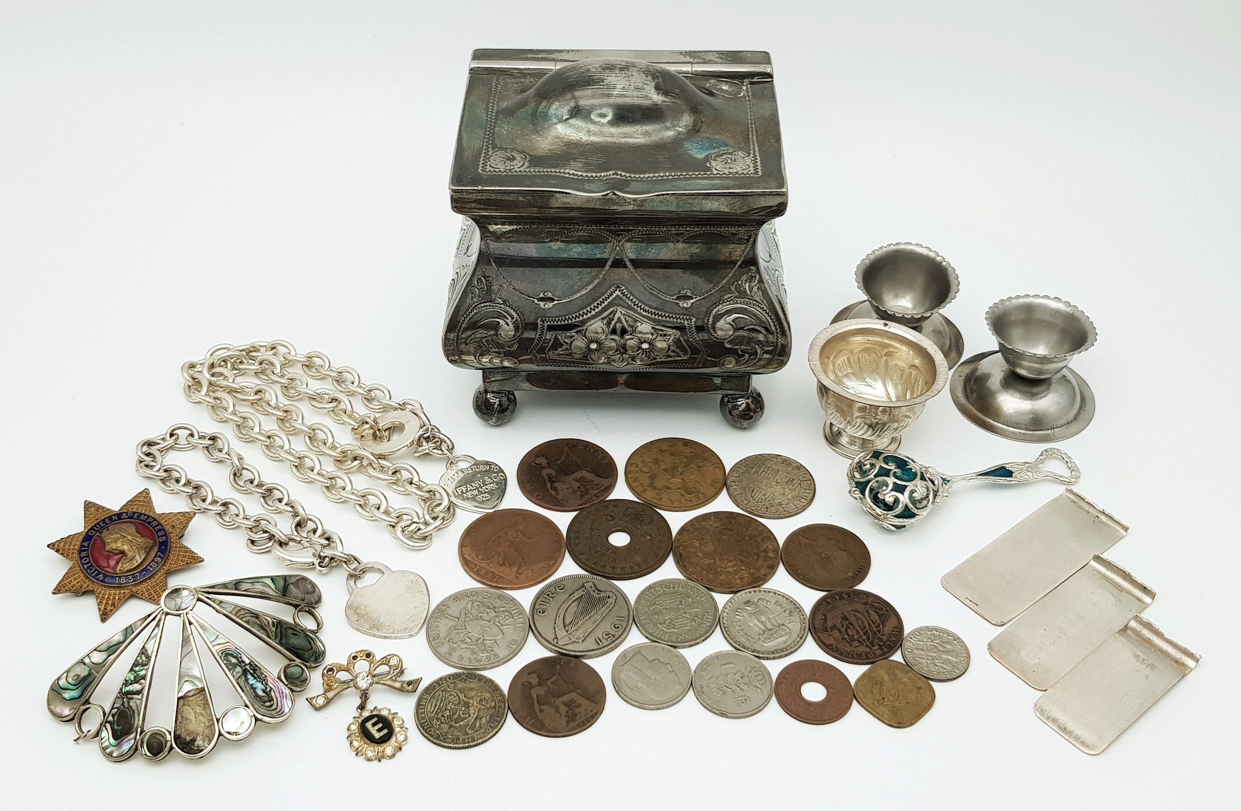 A Potpourri of various collectible items in a silver-plated trinket box