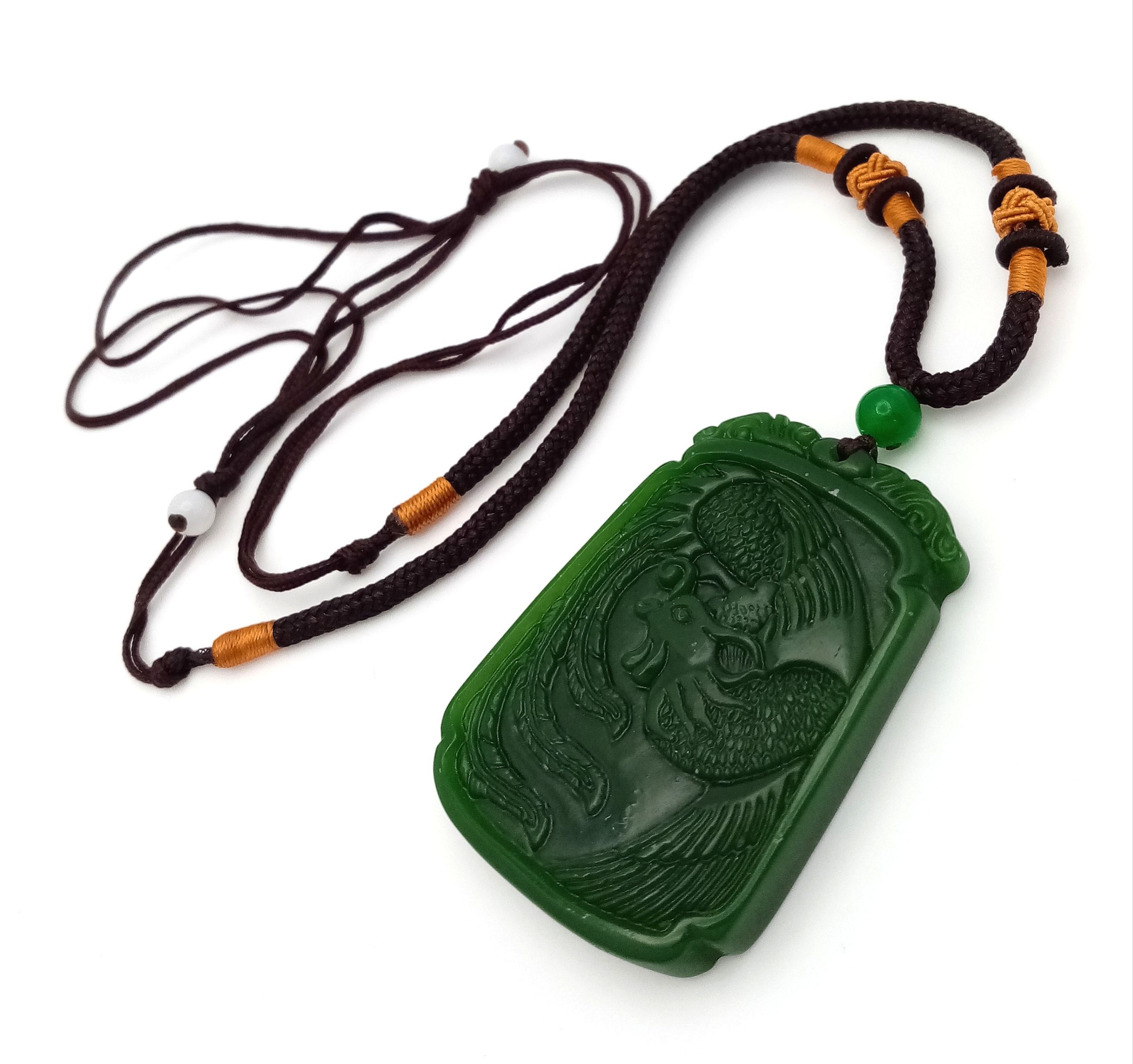 A Green Jade Dragon Pendant with Textile Necklace