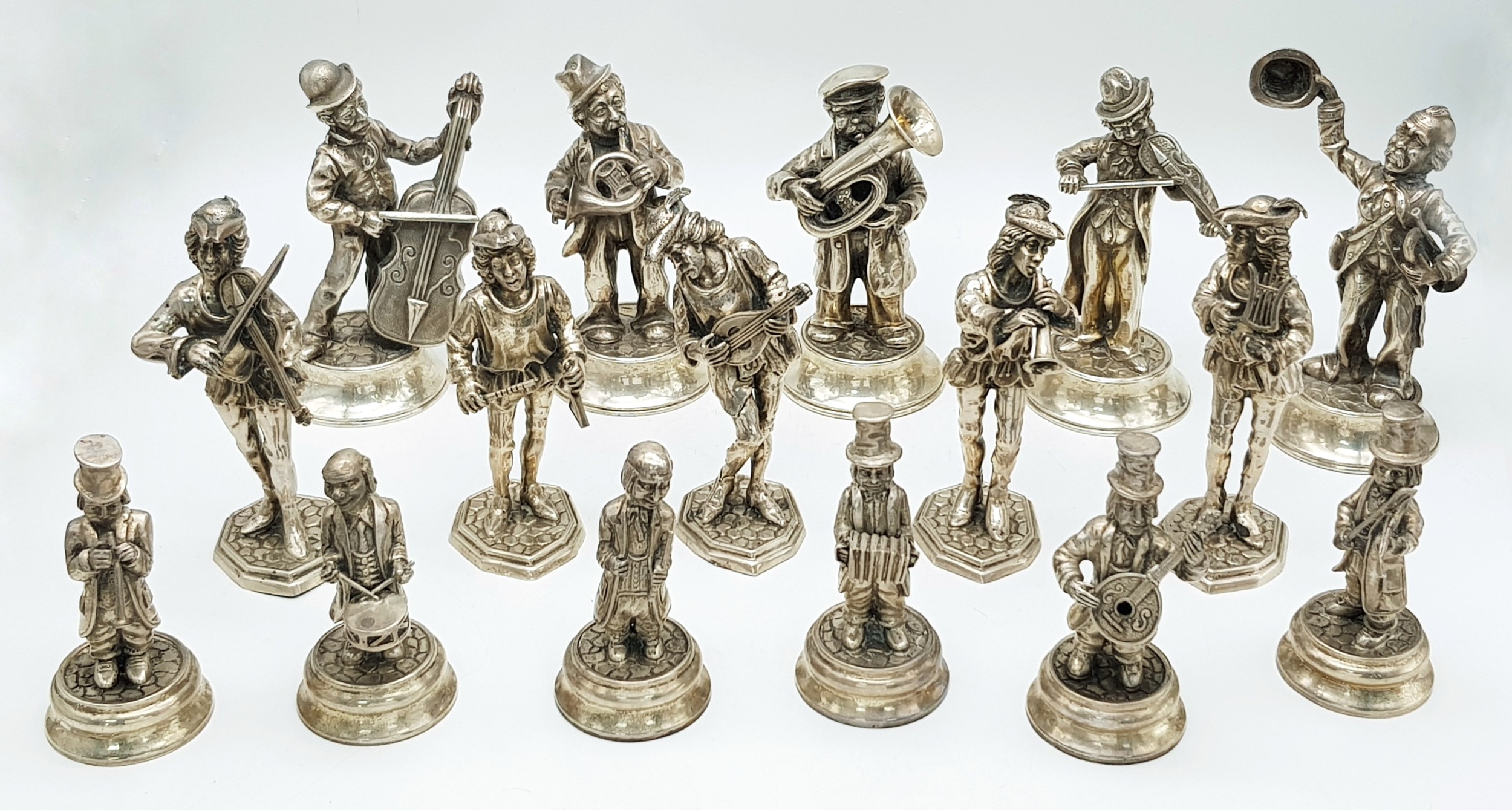 A Collection of Sixteen Spanish Silver Figures of Musicians