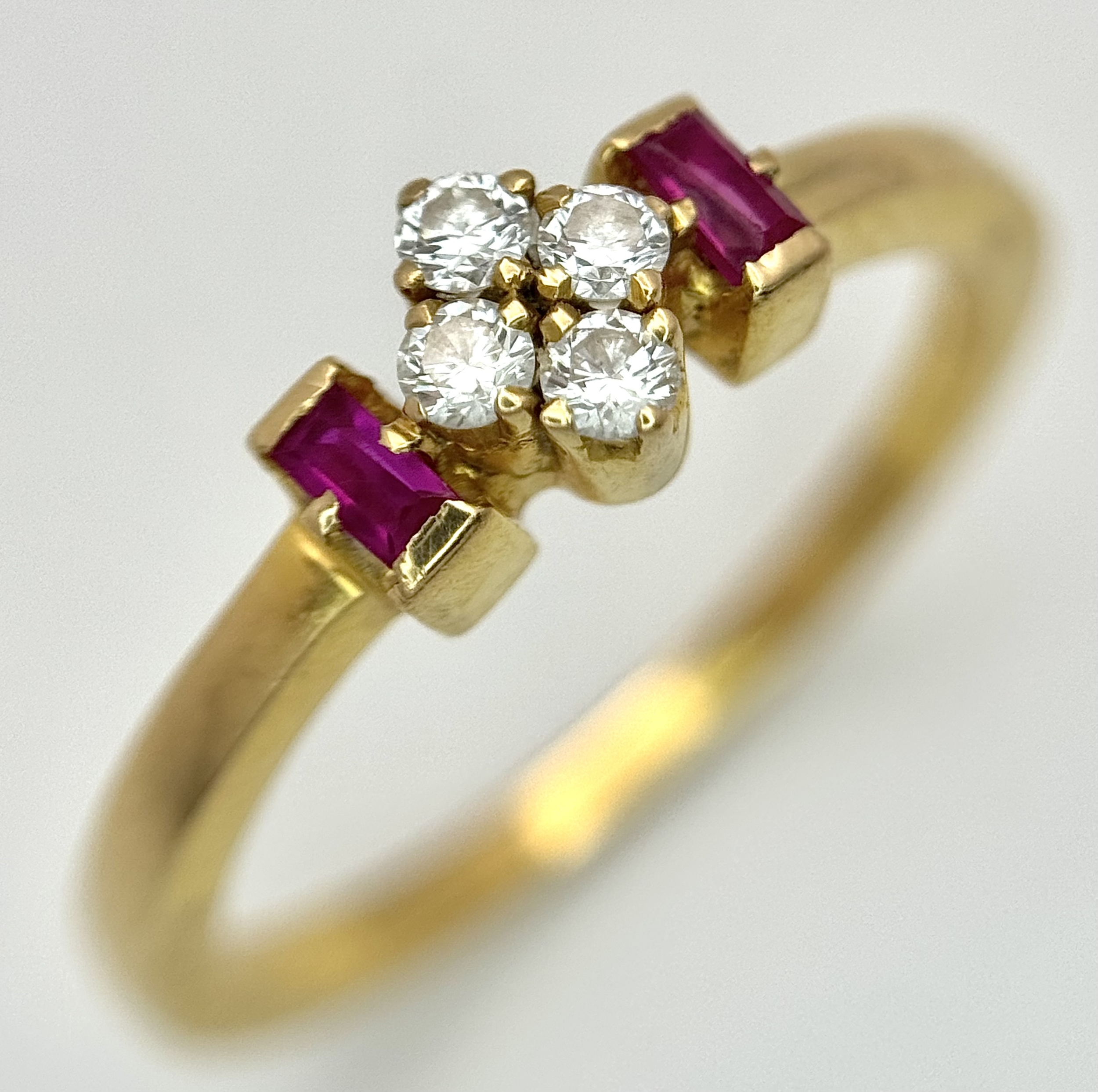 AN 18K YELLOW GOLD, DIAMOND AND RUBY SET RING