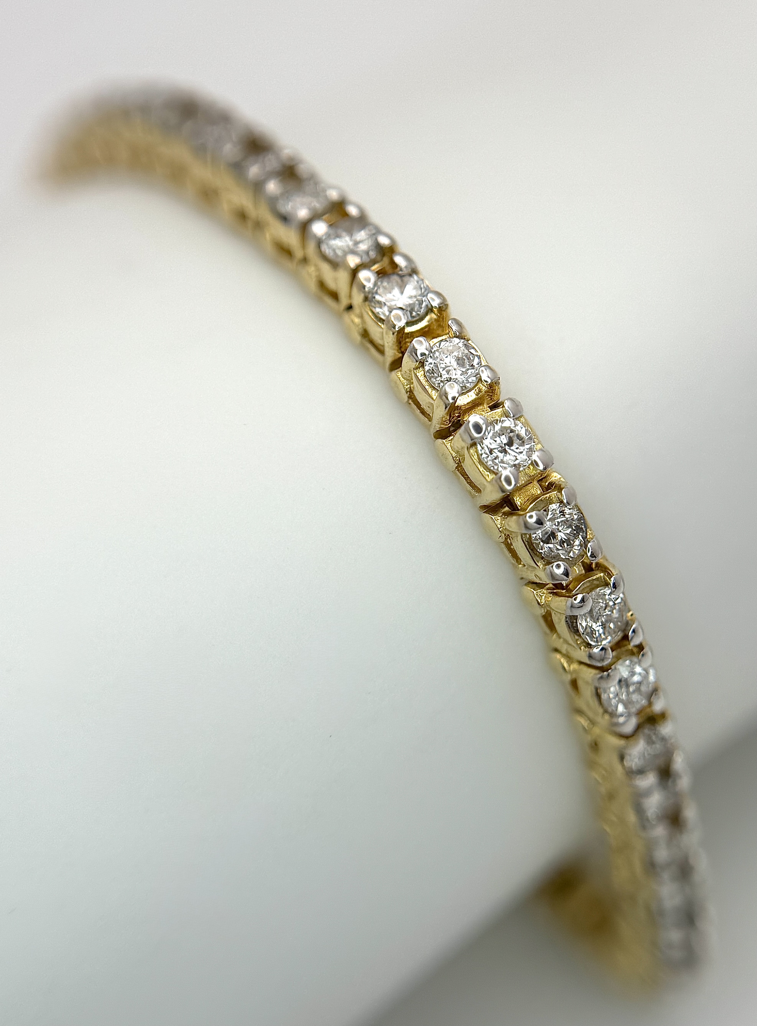 A 14K YELLOW GOLD, DIAMOND SET, TENNIS / LINE BRACELET