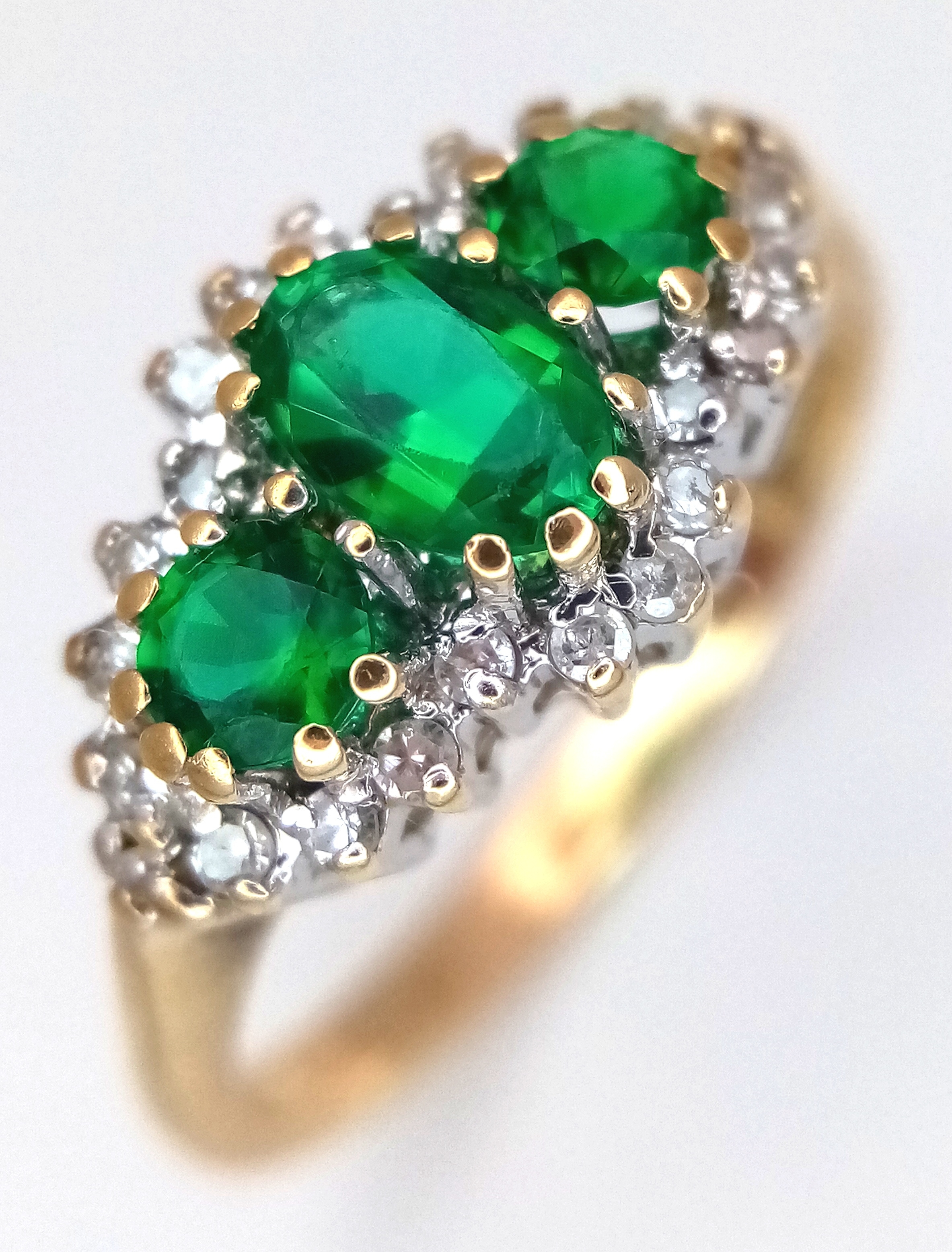 AN 18K YELLOW GOLD, DIAMOND AND GREEN STONE SET RING