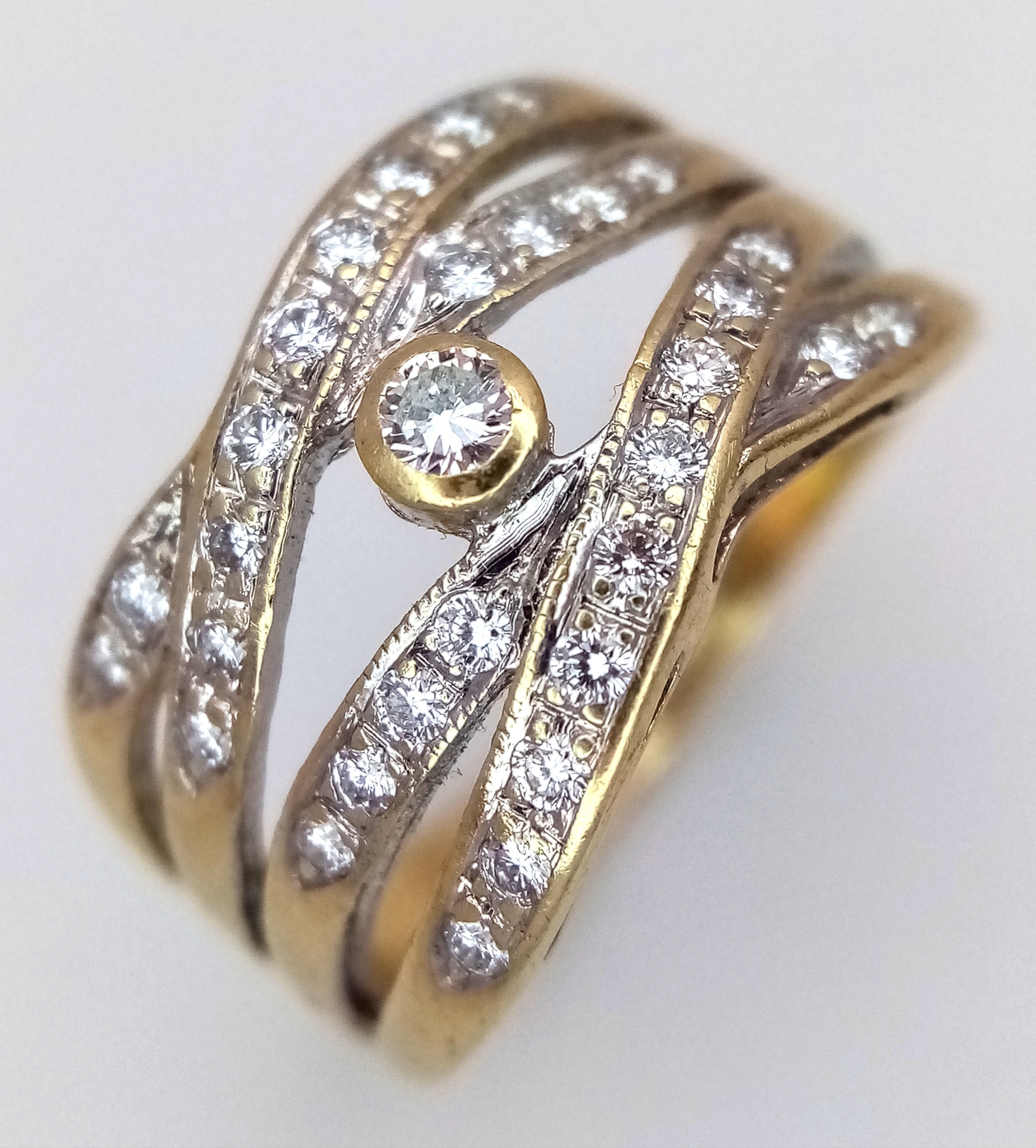 A 9K YELLOW GOLD, DIAMOND SET, 4 ROW, CROSSOVER SPLIT DESIGN RING
