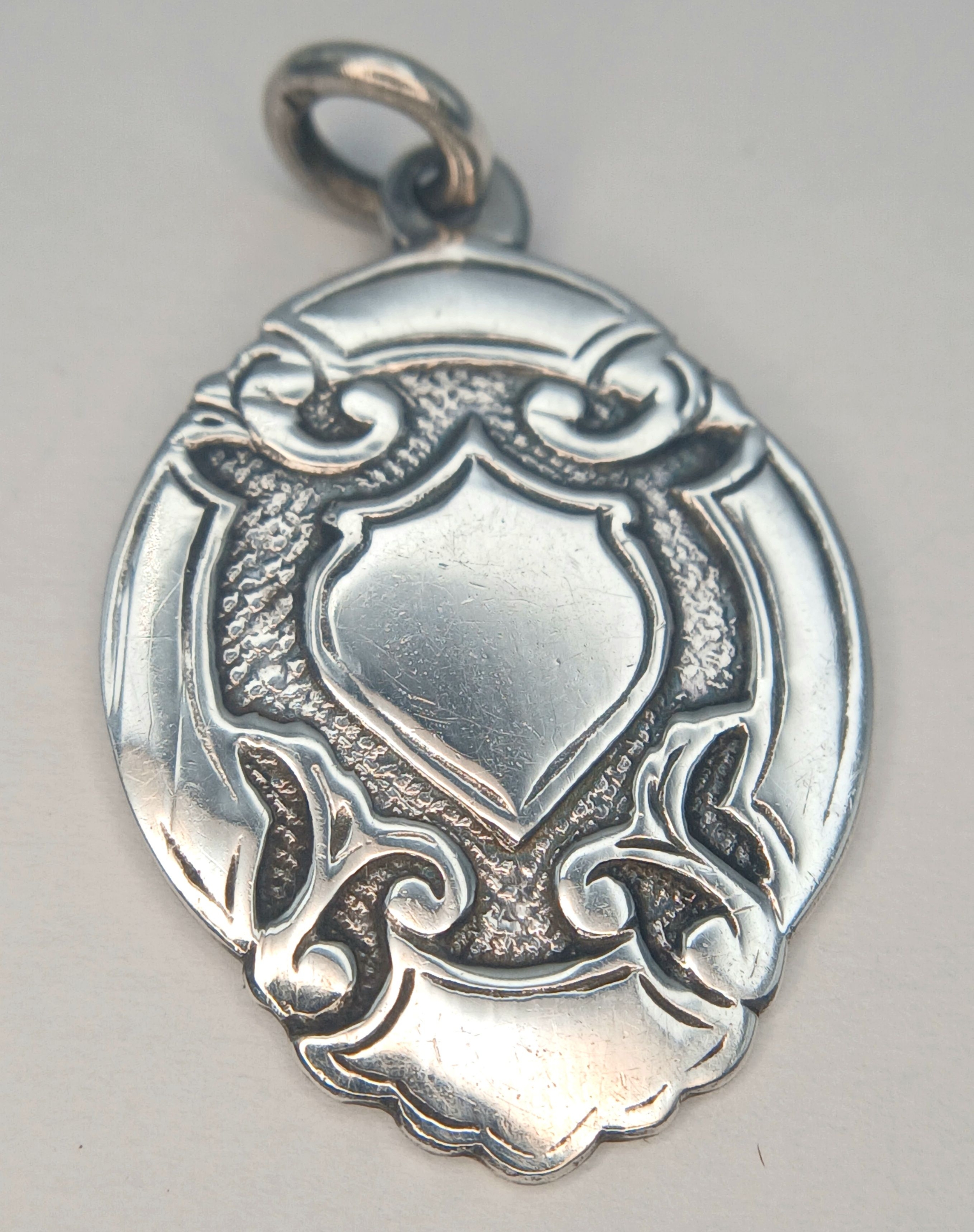 A vintage sterling silver fob pendant