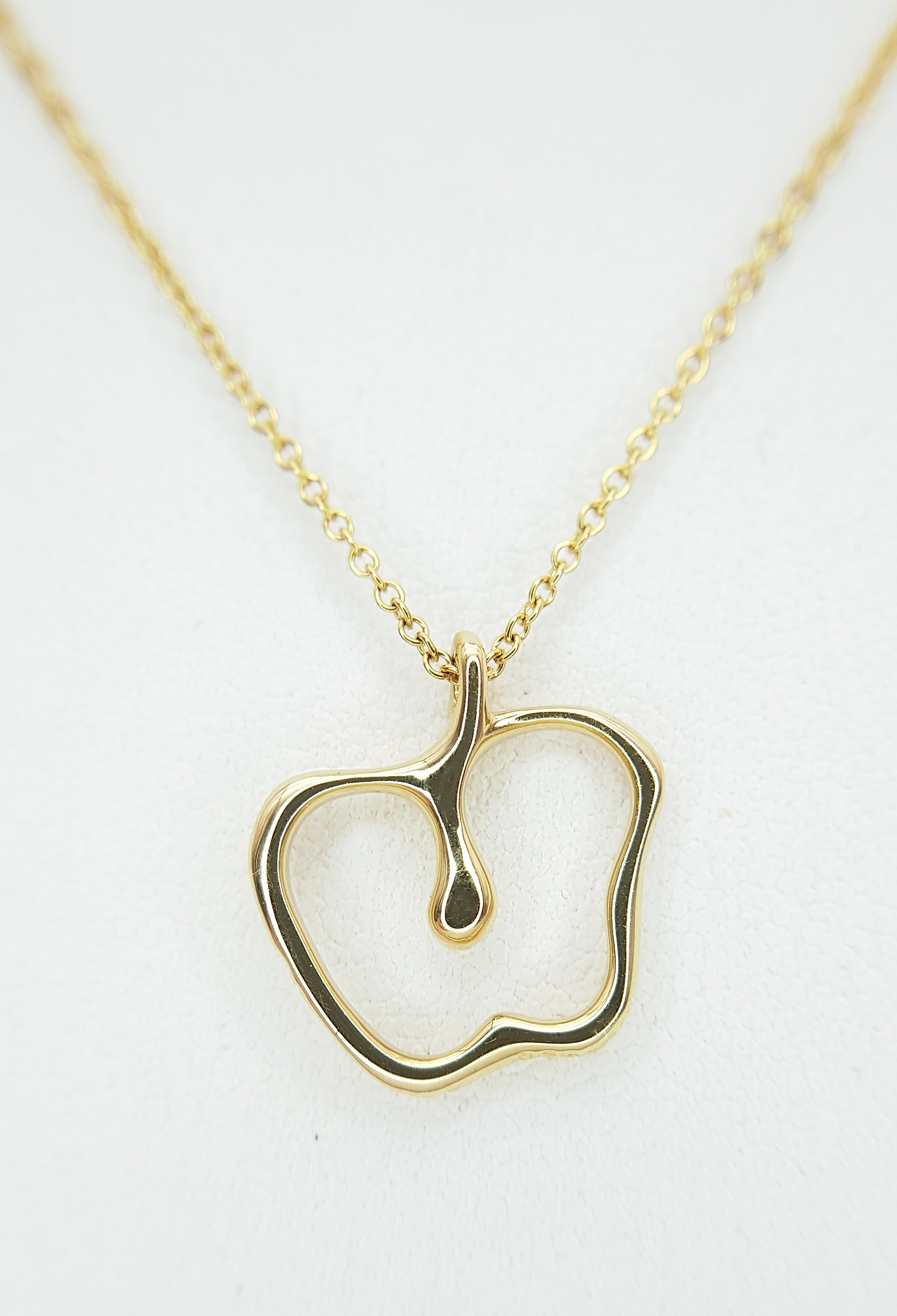 A Tiffany and Co, 18K Gold (Peretti) Apple Pendant on a Tiffany and Co. 18K Gold